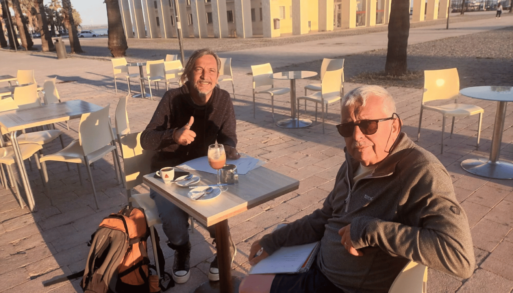 Where conversations flow as easily as the tides — Paul and I at the Paseo Marítimo de Puerto Real.